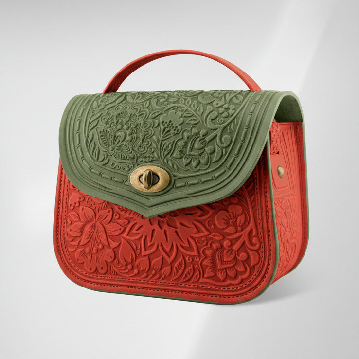 Two-tone embossed handbag with green top section and red bottom section on a light gray background